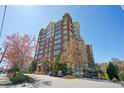 Exterior view of the high-rise building with beautiful landscaping around the property at 3820 Roswell Ne Rd # 317, Atlanta, GA 30342