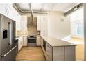 Chic kitchen featuring stainless appliances, white cabinets, and hardwood floors at 3820 Roswell Ne Rd # 317, Atlanta, GA 30342