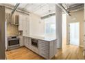 Bright open kitchen with modern cabinets, stainless steel appliances, and hardwood floors at 3820 Roswell Ne Rd # 317, Atlanta, GA 30342