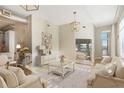 Open-concept living room with neutral tones, modern lighting fixtures, and seamless flow to the outdoor space at 3820 Roswell Ne Rd # 317, Atlanta, GA 30342