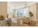 Bright living and dining area with hardwood floors, modern lighting, and access to a balcony at 3820 Roswell Ne Rd # 317, Atlanta, GA 30342