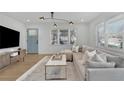 Bright living room featuring modern light fixture, hardwood floors, and a comfortable sofa at 965 Carr Nw St, Atlanta, GA 30318