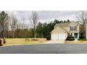 Inviting exterior of a home featuring a two-car garage, manicured lawn, and colorful landscaping at 271 Balaban Cir, Woodstock, GA 30188