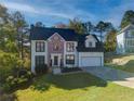 Charming two-story home with brick accents, a manicured lawn, and attached two-car garage at 77 Hunters Grn, Dallas, GA 30157