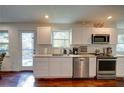 Bright kitchen featuring stainless steel appliances, ample counter space, and a door to a deck at 77 Hunters Grn, Dallas, GA 30157