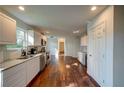 Spacious kitchen with white cabinets, granite countertops, stainless steel appliances, and hardwood flooring at 77 Hunters Grn, Dallas, GA 30157