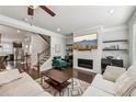 Bright living room with sleek fireplace, mounted TV, hardwood floors, and modern décor at 4125 Barry Pl, Chamblee, GA 30341