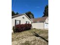 This single Gathering home boasts a two car garage and green front lawn with lush shrubbery around the front window at 413 Remington Ct, Villa Rica, GA 30180