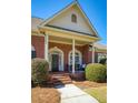 Charming brick home featuring a covered front porch with welcoming entrance at 8005 Sweet Creek Rd, Johns Creek, GA 30097