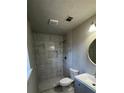 Modern bathroom featuring a tiled walk-in shower, hexagon tile floor, and contemporary fixtures at 309 Peachtree Dr, Riverdale, GA 30274
