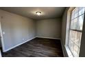 Bright, airy bedroom with new laminate floors and a large window at 309 Peachtree Dr, Riverdale, GA 30274