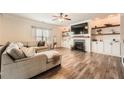 Bright living room features a fireplace with built-in shelves and plush seating at 636 Georgia Way, Woodstock, GA 30188