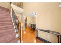 Open foyer with hardwood floors, staircase and view into the dining room at 924 Evian Nw Dr, Kennesaw, GA 30152