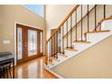 Inviting foyer featuring hardwood floors, a staircase, and a decorative glass front door at 924 Evian Nw Dr, Kennesaw, GA 30152