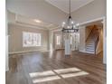 Spacious living room with hardwood floors, coffered ceiling, and staircase access at 167 Pinewood Dr, Covington, GA 30014