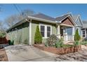 View of the side of the home with green siding and a long driveway at 280 Josephine St, Atlanta, GA 30307