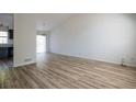 Bright and spacious living room featuring new wood floors, a sliding glass door, and a neutral color palette at 6136 Marbut Rd, Lithonia, GA 30058