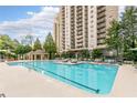 Resort-style pool area with comfortable lounge seating and lush landscaping at 795 Hammond Dr # 1108, Atlanta, GA 30328