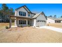 Charming two-story home featuring a covered porch and a two-car garage at 2320 Ridge View Dr, Loganville, GA 30052