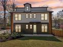 Modern two-story home with a stylish exterior, a colorful front door, and a twilight sky backdrop at 3087 Alston Dr, Decatur, GA 30032