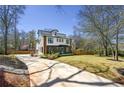View of modern two-story home featuring a long driveway and a manicured front lawn at 3087 Alston Dr, Decatur, GA 30032