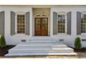 Elegant front door with sidelights and white stone steps at 446 Cove Ne Dr, Marietta, GA 30067