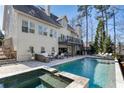 Beautiful backyard with a luxurious in-ground pool, hot tub, patio, and outdoor seating area at 230 Hardscrabble Rd, Roswell, GA 30075