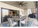 Covered patio with outdoor dining set, ceiling fan and easy access to the indoors at 230 Hardscrabble Rd, Roswell, GA 30075