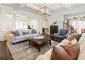 Spacious living room with coffered ceilings, hardwood floors, and sophisticated decor and furnishings at 230 Hardscrabble Rd, Roswell, GA 30075
