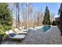 Backyard pool and spa featuring patio with lounge chairs, ideal for relaxation at 230 Hardscrabble Rd, Roswell, GA 30075