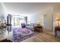 Bright living room with a plush rug, light-filled with sliding door access to a private outdoor space at 2479 Peachtree Ne Rd # 104, Atlanta, GA 30305