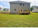 Spacious backyard with newly laid sod and a small wooden deck, perfect for outdoor entertaining at 305 Melanie Ct, Bowdon, GA 30108