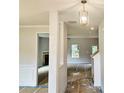 Bright entryway featuring a decorative light fixture and views into the living room and dining area at 305 Melanie Ct, Bowdon, GA 30108