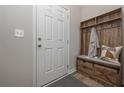 Cozy entryway with wooden storage bench, hooks, and drawers at 2960 Fareed St, Douglasville, GA 30135