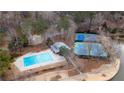 Aerial view of a community pool, tennis courts, and lake at 330 Teal Ct, Roswell, GA 30076
