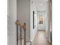 Hallway view with stairs and a view to the front entrance, featuring neutral walls and wood-look flooring at 508 Red Terrace, Marietta, GA 30060