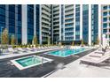 Relaxing outdoor pool and hot tub area with lounge chairs and views of the building at 2425 Peachtree Ne Rd # 1104, Atlanta, GA 30305