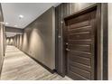 Modern apartment hallway featuring wood-look flooring, stylish wallpaper and multiple recessed lights at 1080 Peachtree Ne St # 1909, Atlanta, GA 30309