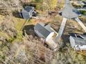 Aerial view of gray roofed home with backyard and wooded surroundings at 122 S Mill Creek Ct, Woodstock, GA 30188
