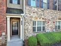 Close-up of the stone exterior, front door and small landscaped area at 1222 Poston Se Pl, Smyrna, GA 30080