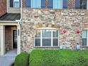 Close-up of the stone exterior, front door and small landscaped area at 1222 Poston Se Pl, Smyrna, GA 30080