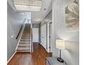 Bright foyer with gleaming hardwood floors, staircase, chandelier, and elegant decor at 1222 Poston Se Pl, Smyrna, GA 30080