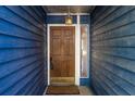 Classic wood front door with decorative lighting and side window at 2645 Trotters Walk Trl, Snellville, GA 30078