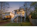 Spacious backyard with a charming deck and stairs, surrounded by mature trees and fencing at 213 Oak Ln, Decatur, GA 30030