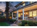 Inviting front porch featuring classic columns, decorative lighting, and meticulously kept landscaping at 213 Oak Ln, Decatur, GA 30030