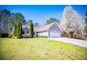 Charming single-Gathering home with well-maintained lawn, two-car garage, and inviting curb appeal at 314 Meadow Spring Dr, Temple, GA 30179