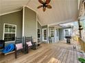 Inviting covered porch with rocking chairs, ceiling fan, and ample space for outdoor living and entertaining at 401 Carrie Kathleen Ter, Carrollton, GA 30116