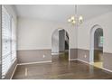 Dining room with natural light and arched entryways to stairs and other rooms at 4956 Braeburn Nw Trce, Acworth, GA 30102