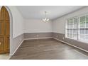 Formal dining room with hardwood floors, chandelier, and neutral color scheme at 4956 Braeburn Nw Trce, Acworth, GA 30102