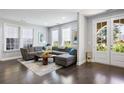 Spacious living room featuring hardwood floors, neutral paint, and large windows that provide lots of natural light at 6616 Aria Village Dr, Atlanta, GA 30328